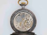 a silver pocket watch with a gold chain on it