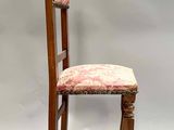 a wooden chair with a red and white upholstered seat