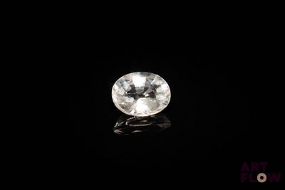 a close up of a white diamond on a black surface