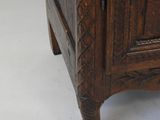 a wooden cabinet that has a mirror on top of it