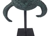 an image of a bronze helmet on a stand on a white background