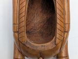 a wooden urinal that is on the wall
