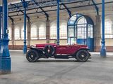a red car parked in a large building with a blue pole