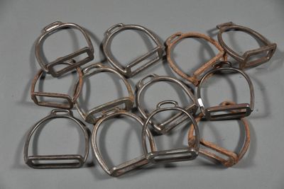 a lot of metal horse bitts on a gray surface