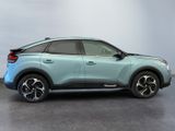 the rear end of a light blue suv parked in a room