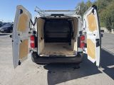 a white van with its doors open in a parking lot