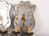 two decorative mirrors on the wall next to each other