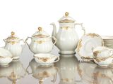 a picture of a white and gold tea set on a table