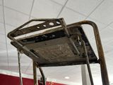 a metal chair that is hanging from the ceiling