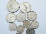 several coins are arranged in a circle on a white surface
