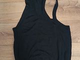 the back of a black sports bra top on a wooden floor