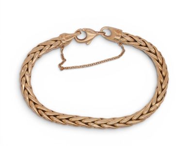 a close up of a gold bracelet on a white background