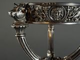 a silver plate with a lion head on it