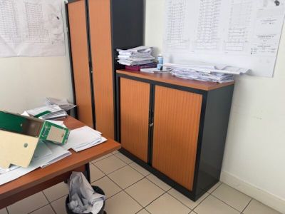 a desk with a bunch of papers on top of it