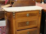 a lot of antique furniture on display in a room