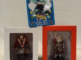 two boxes of anime figurines are sitting next to each other