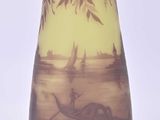 a vase that has a picture of a boat in the water