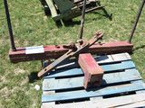 a wooden pallet with a hammer on it in the grass