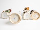 three miniature figurines that are sitting on a table