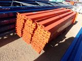a close up of a pile of orange and blue steel beams