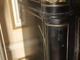 a close up of a clock on a stand in a room