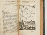 an open book with a drawing of a city in the middle of it