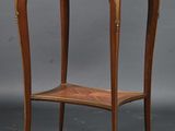 an old wooden table with a glass top and a shelf
