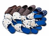 several pairs of slippers are lined up on a white surface