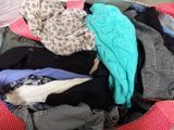 a suitcase full of clothes that is sitting on the floor