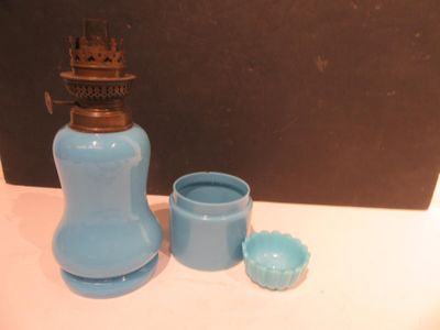 a blue vase and a blue cup sitting on a table
