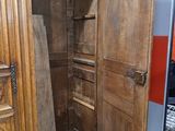 a wooden cabinet with a door open in a room