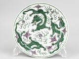 green and white plate with a dragon design on it