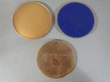 three medals are shown on a white surface with blue and gold