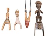 three wooden figurines are sitting next to each other on a white surface