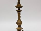 pair of antique brass candelabs on a stand