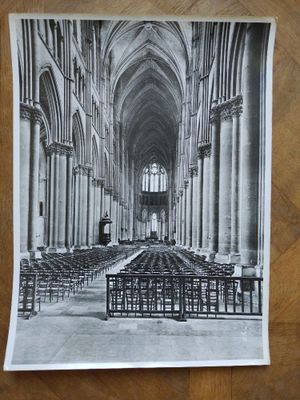 a black and white photo of a church with rows of pews