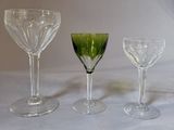 three wine glasses sitting next to each other on a table