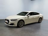 the white audi sedan is parked in a large room