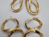 three pairs of gold rings and a pair of earrings