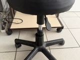 a black stool that is sitting on a tile floor