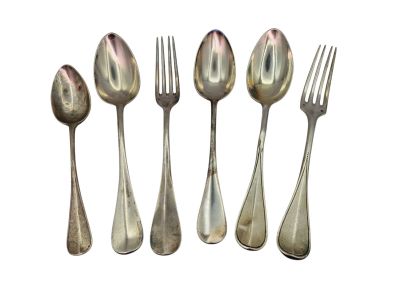 four silver spoons and a fork on a white background