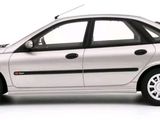 a silver car that is parked on a white surface