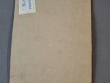 a brown piece of paper with a sticker on it