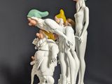 a figurine of a group of people on a pedestal