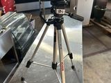 a tripod that is sitting on a table in a kitchen