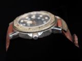 a watch that is on display on a black surface