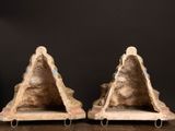 pair of antique stone bookends on stand on wooden table