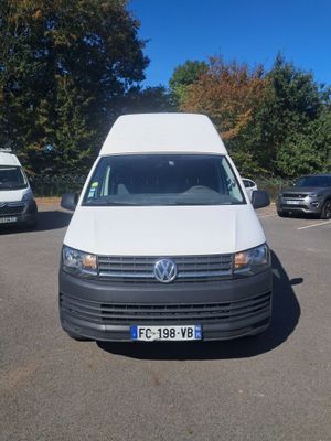the white van is parked in a parking lot with other cars