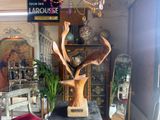 a statue of a deer in a vase on a table