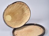 a small wooden box with a wooden handle on a white surface